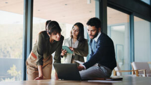 Collaboration, laptop and project management with business people in office for plan development. Computer, meeting and tablet with corporate employee team in workplace boardroom for discussion
